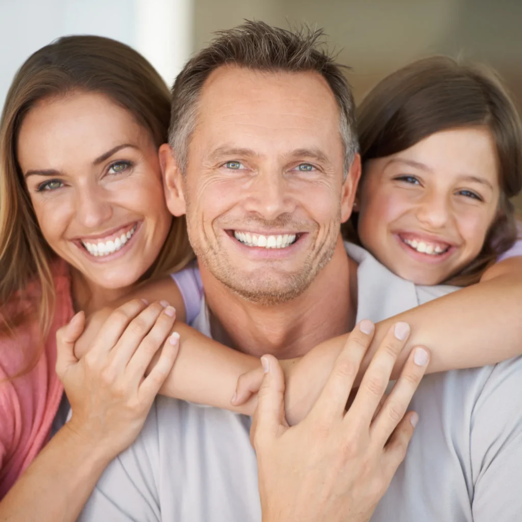 Smiling family with bright white teeth after receiving cosmetic dental care in Fairfield