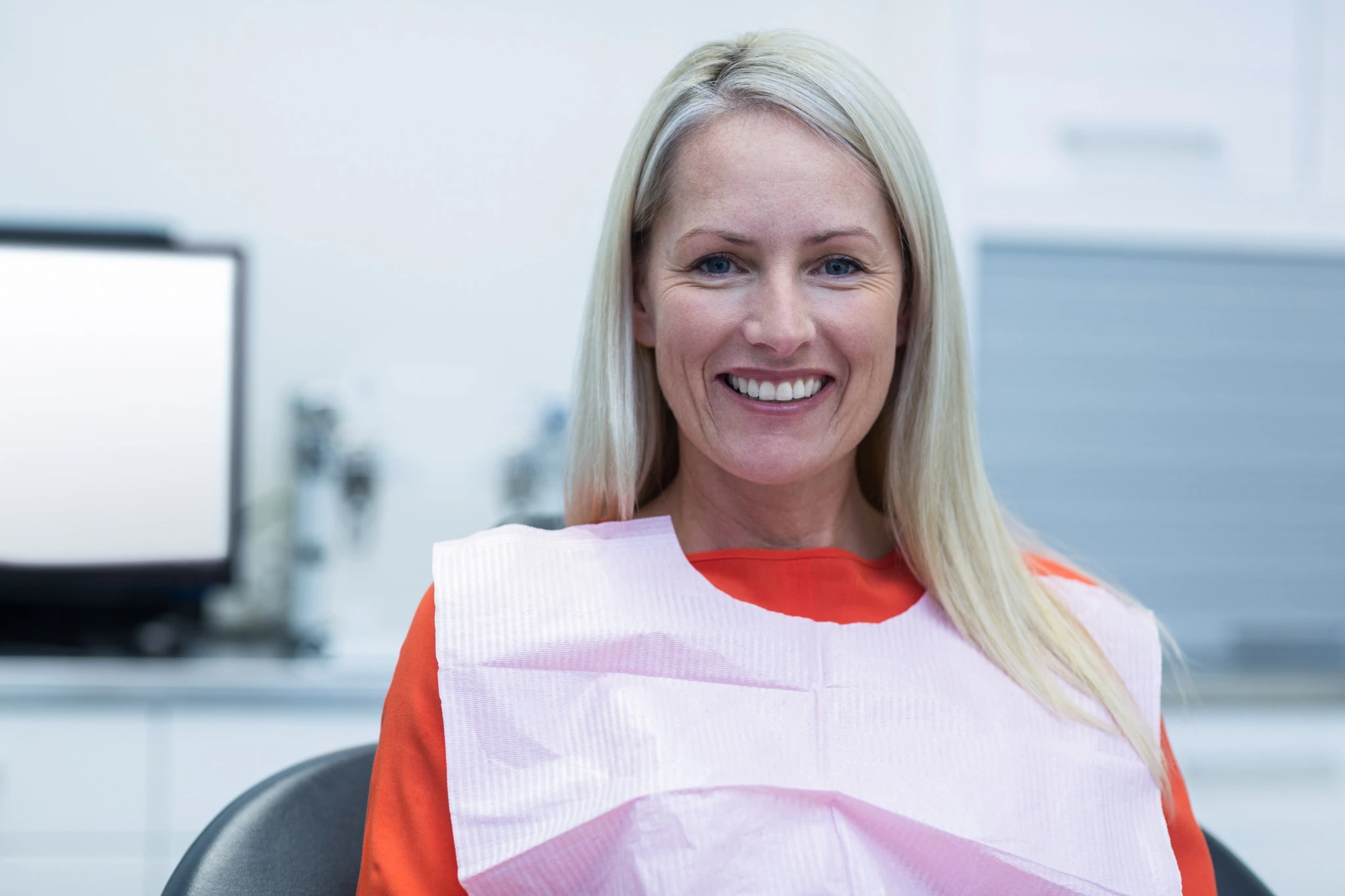 Smiling woman after implant consultation