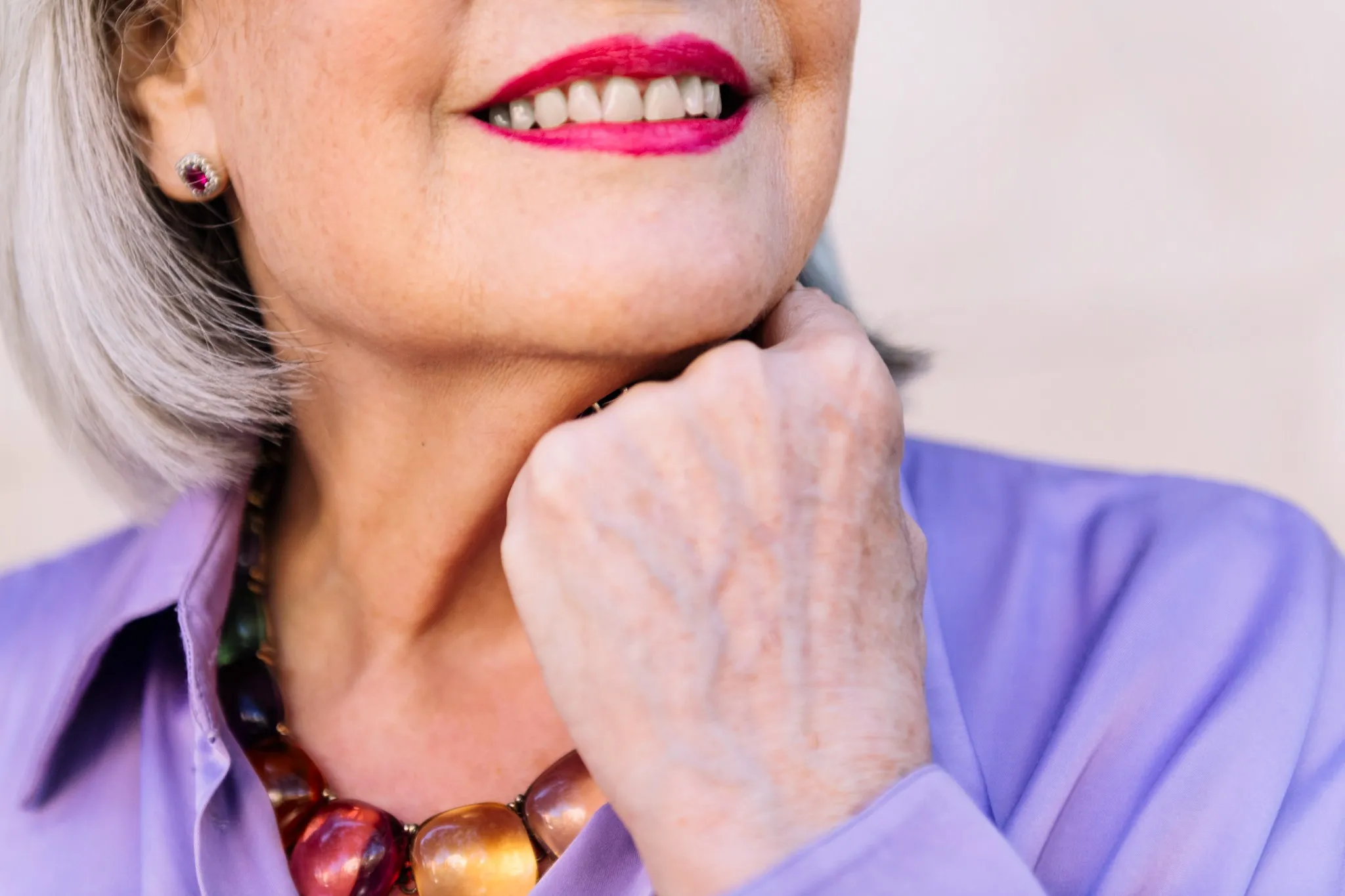 Close-up of smiling senior woman showcasing her new full mouth dental implants at Fairfield Dentistry