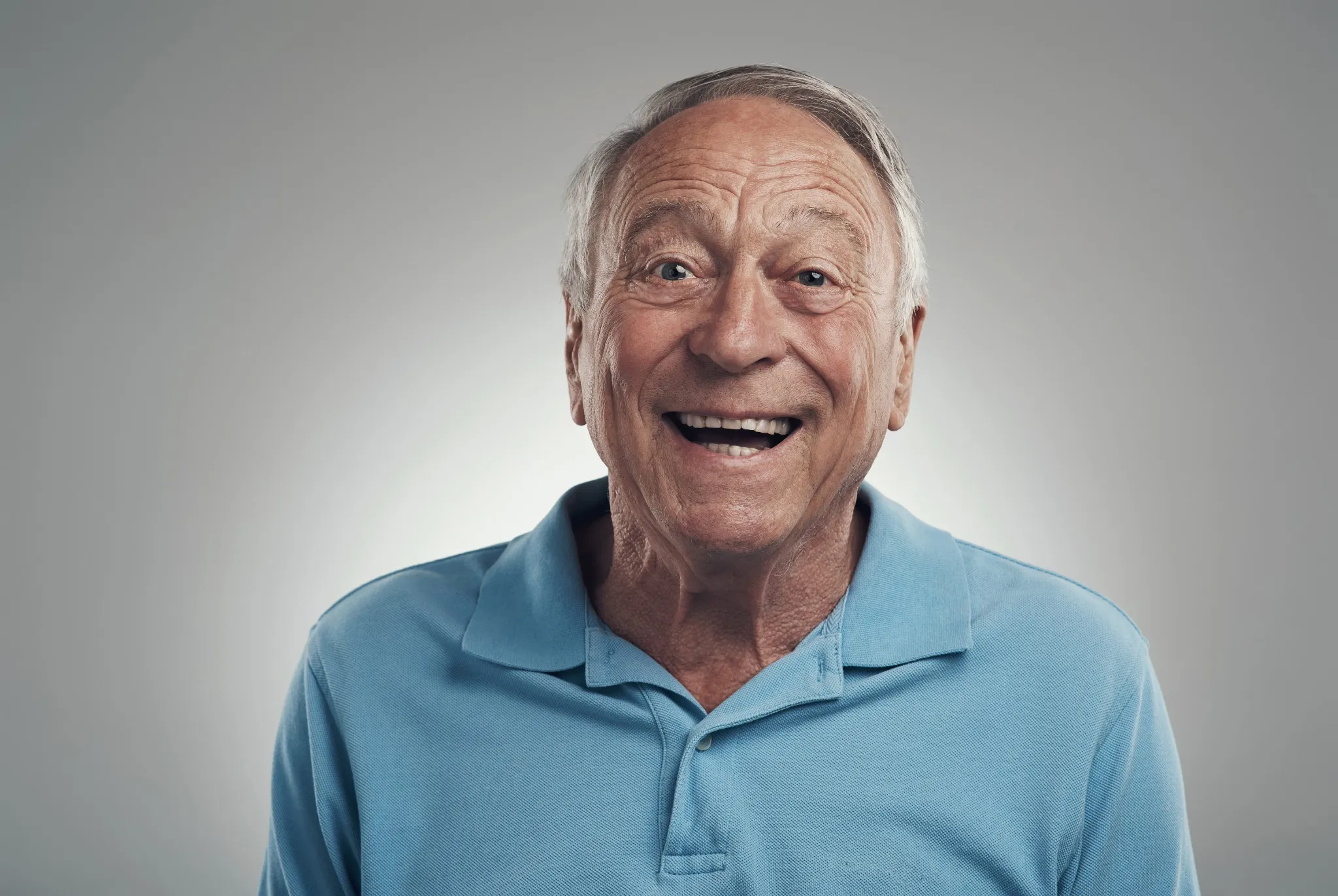 Happy senior man smiling confidently after dental implant treatment near Travis Air Force Base