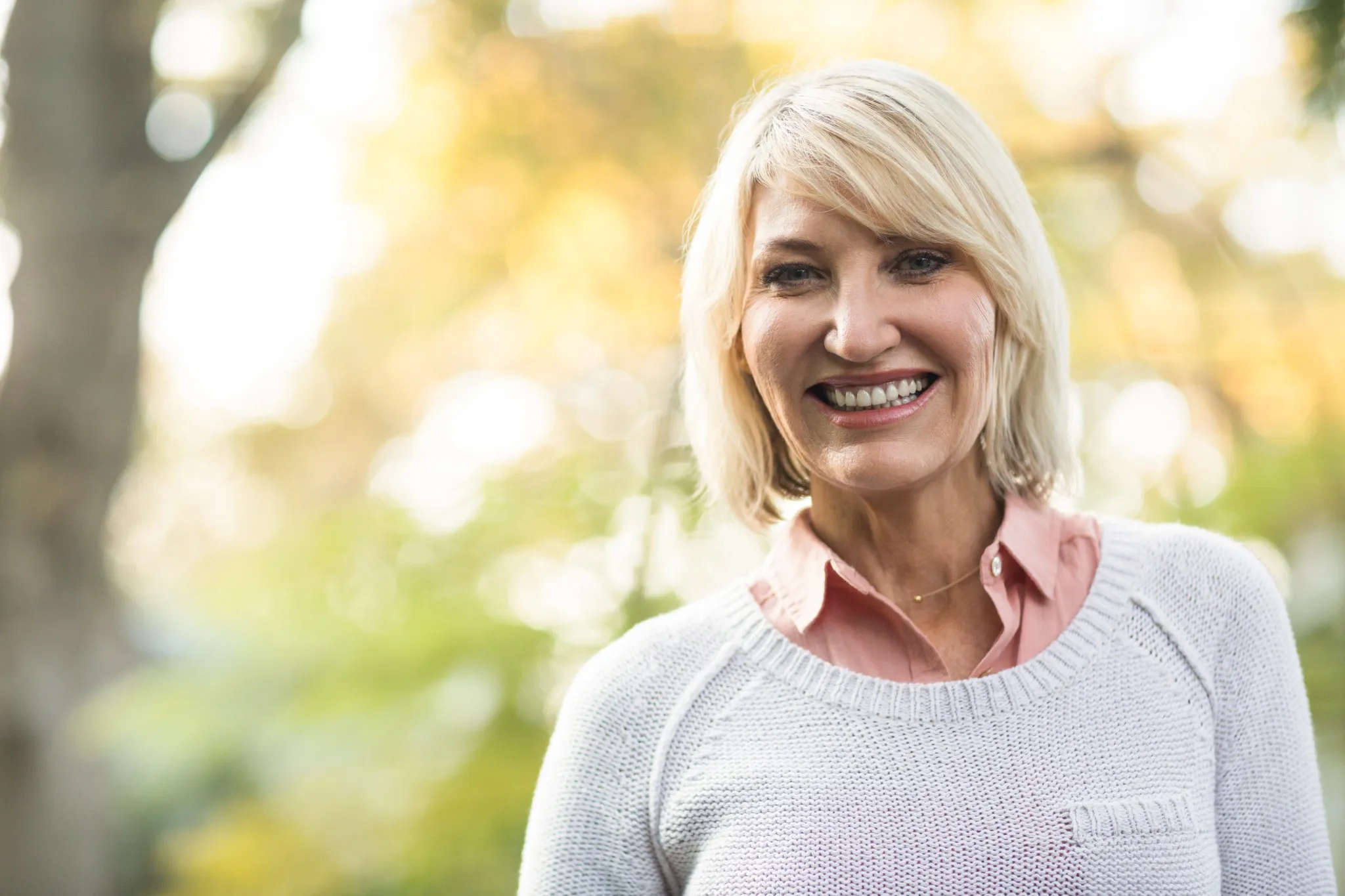 Smiling mature woman after dental implants near Travis AFB